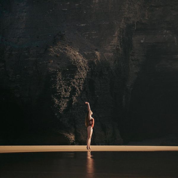 Silhouette of a person in a calm meditative yoga pose against a serene backdrop